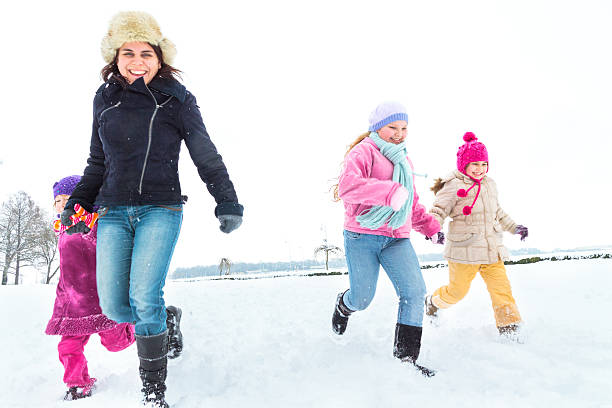 istock Cute family having fun in the snow 498741250