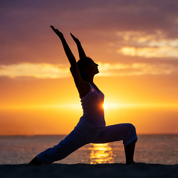 istock Caucasian woman practicing yoga at seashore 498741578