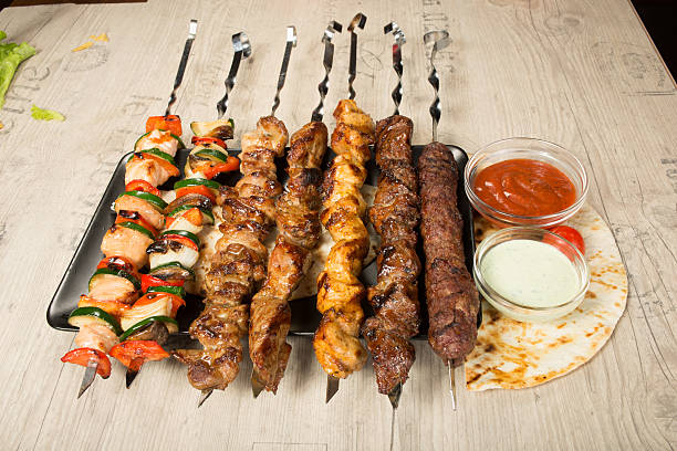 istock set shashlik. kebab skewer, black rectangular plate. sauce and onions 498741602