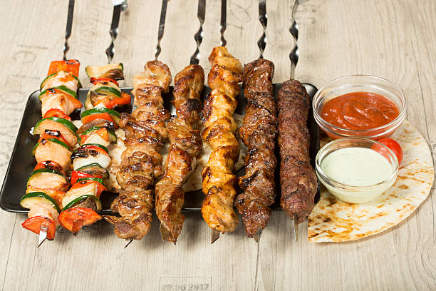 istock set shashlik. kebab skewer, black rectangular plate. sauce and onions 498741856