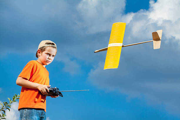 istock Little boy playing with handmade RC airplane toy 498741876