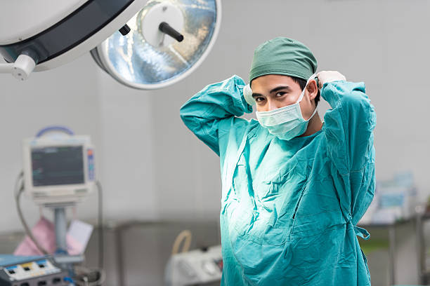 surgeon in theatre Getting Ready To Operate On A Patient stock photo