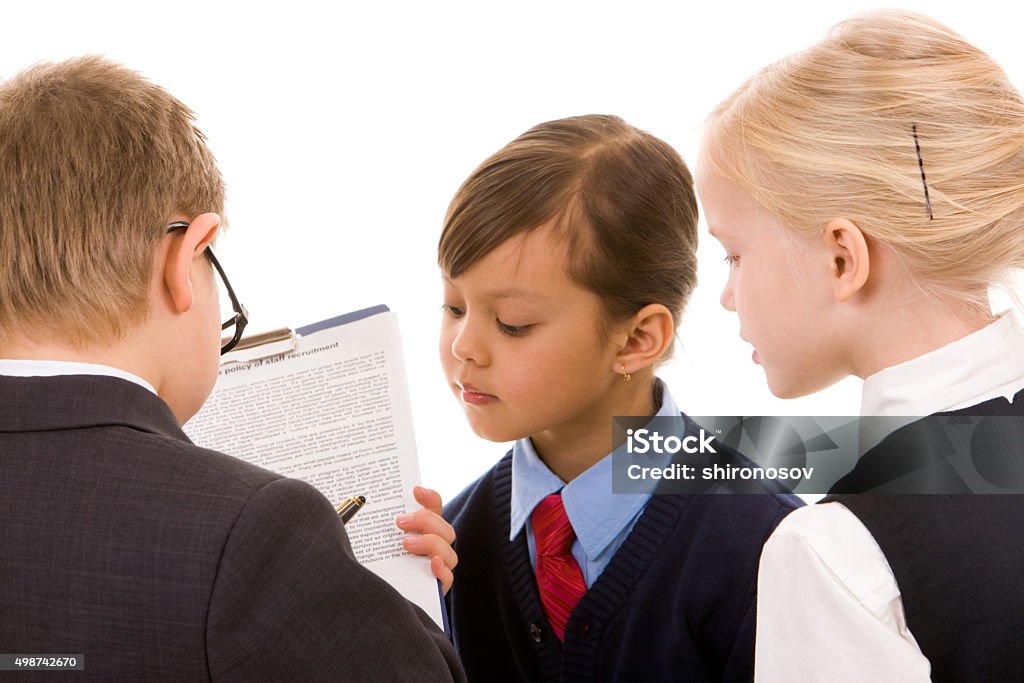 Making a deal Portrait of attentive girl looking at boy signing papers 2015 Stock Photo