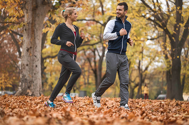 istock Smiling athletes running together in the park and communicating. 498742766
