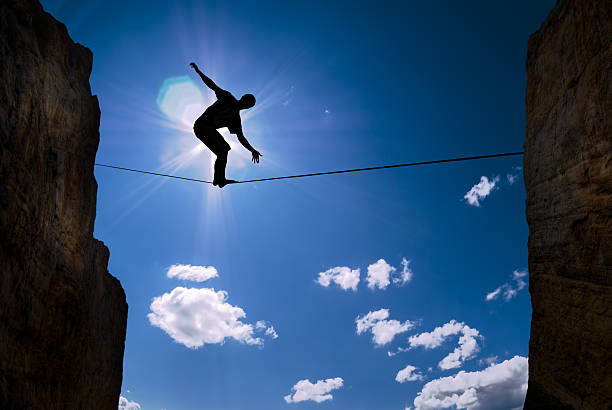 istock Concept of risk taking man balancing on the rope 498742862