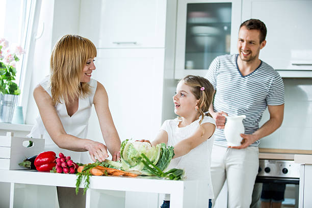 istock Young family with fresh vegetables in kitchen 498744156
