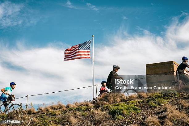 Cyclers Run Up The Hill Stock Photo - Download Image Now - American Flag, Cycling, 2015