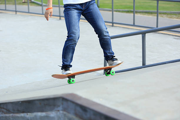 istock skateboarding legs at skatepark 498745336