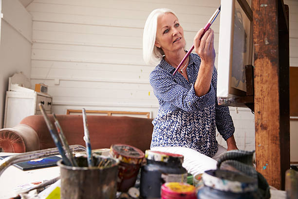 istock Female Artist Working On Painting In Studio 498745504