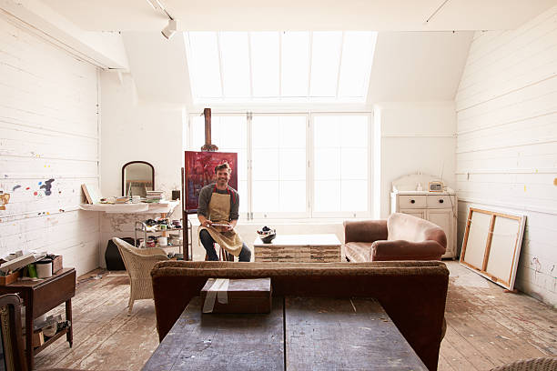 istock Male Artist Working On Painting In Bright Daylight Studio 498745928
