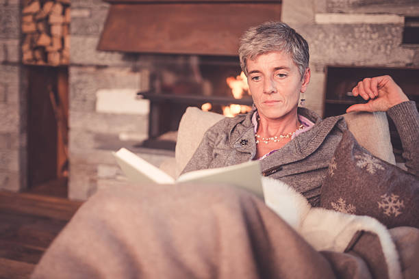 istock Senior Woman Reading on Sofa 498746740