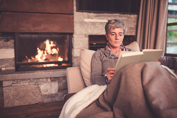istock Senior Woman Reading on Sofa 498746786