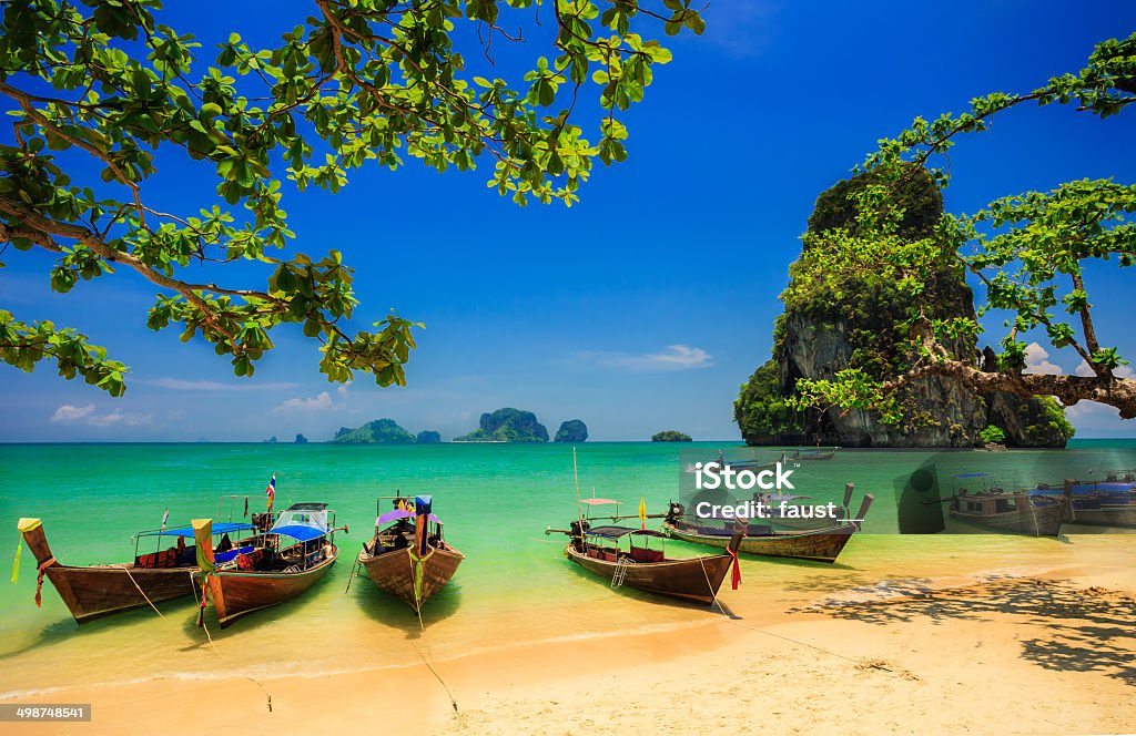 Traditional longtail boats Traditional longtail boat at sunset on tropical island, Thailand Island Stock Photo