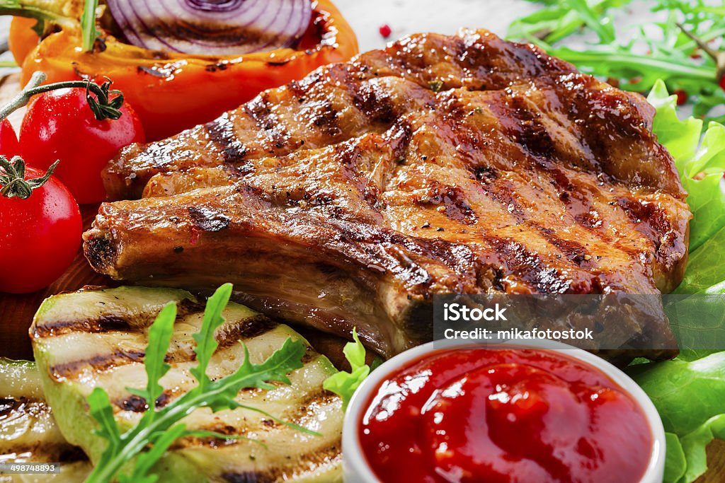 Grilled Pork Chops with vegetables Animal Bone Stock Photo