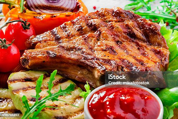Grilled Pork Chops With Vegetables Stock Photo - Download Image Now - Animal Bone, Barbecue - Meal, Barbecue Grill