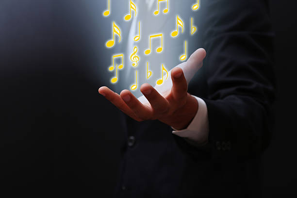 istock Businessman emitting musical symbol on his hand 498749507