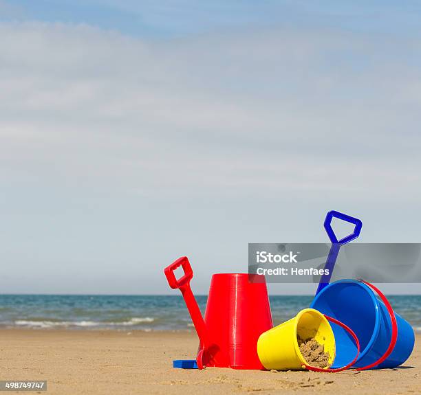 Beach Sea Buckets Spades And Distant Boat Stock Photo - Download Image Now - Beach, Blue, Brass