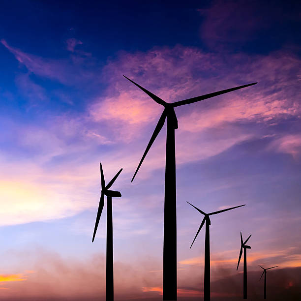 istock wind turbine silhouette on colorful sunset 498750317