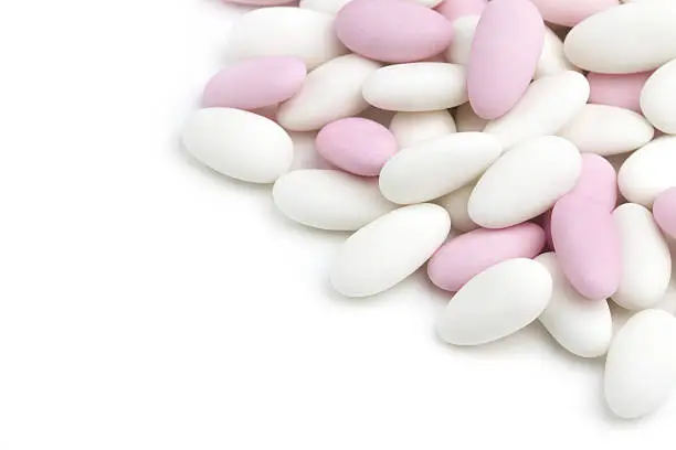 heap of white and pink sugared almonds