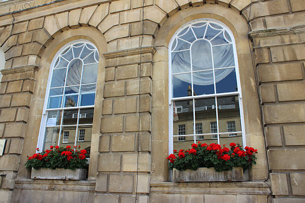 istock Stone window boxes with red flowers (geraniums / pelargoniums), Georgian house 498751255