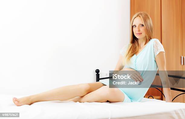 Pregnant Woman Sitting On Sheet In Bed Stock Photo - Download Image Now - Adult, Adults Only, Anticipation