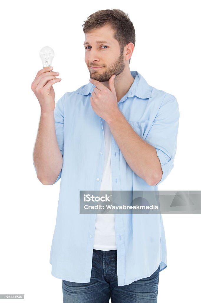 Handsome model holding a bulb Handsome model on white background holding a bulb 20-29 Years Stock Photo