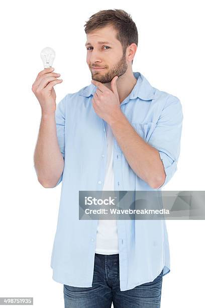 Handsome Model Holding A Bulb Stock Photo - Download Image Now - 20-29 Years, Adult, Adults Only