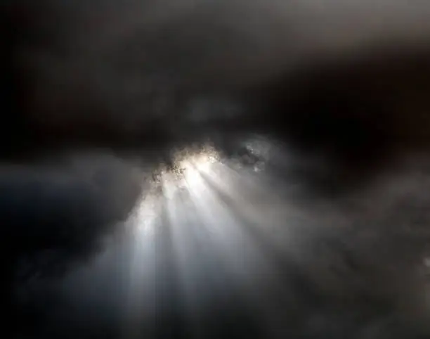 Photo of Light rays through clouds