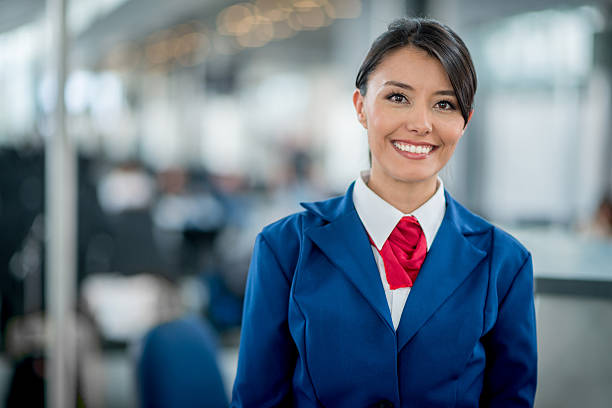 Flight attendant smiling Friendly flight attendant smiling at the airport crew stock pictures, royalty-free photos & images