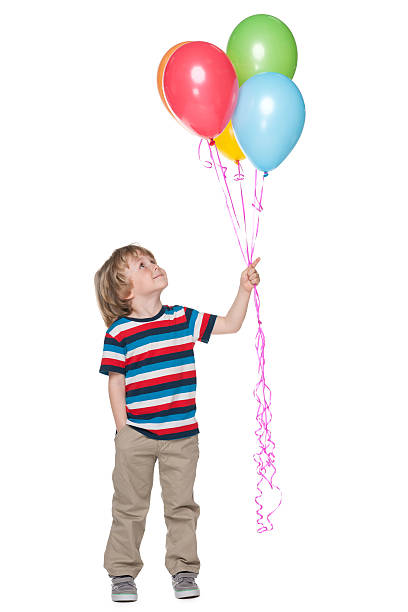 istock Smiling little boy with balloons 498753327