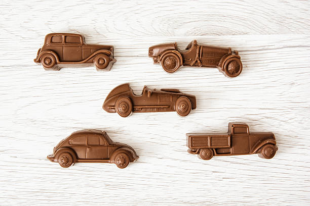 Set of chocolate car figures on wooden background