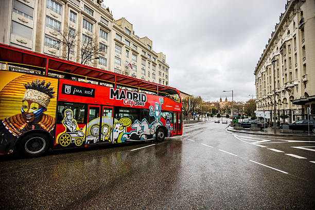 Madrid, Spain  - December 25, 2013: Madrid City Tour Bus on street in city center. Rainy day, few people on the street. 