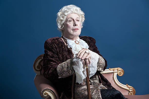 istock Retro baroque man with white wig holding a walking stick. 498764617