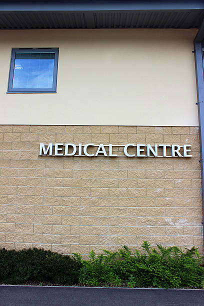 istock Image of modern silver Medical Centre sign, pale brick wall 498765439