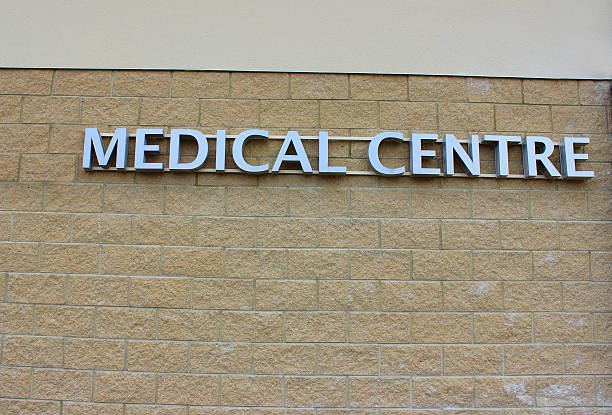 istock Image of modern silver Medical Centre sign, pale brick wall 498765441