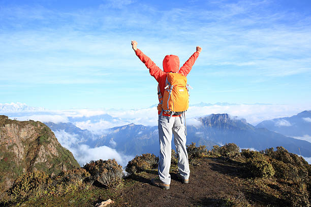 istock young woman hiker on beautiful rolling clouds mountain peak 498765686
