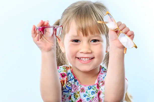 Photo of Cute girl holding glasses.