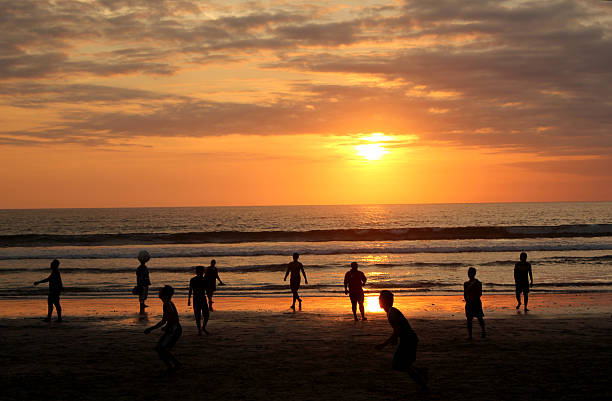 Zanzibar, Tanzania - October 13, 2013: Local kids playing soccer to sunset on the beach of fisherman's village Pwani Mchangani of Zanzibar.