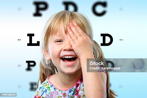 Girl Having Fun At Vision Test Stock Photo - Download Image Now - Child, Eye Exam, Eye