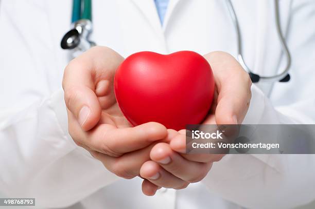 Doctor Protecting A Heart Stock Photo - Download Image Now - Adult, Cardiologist, Close-up