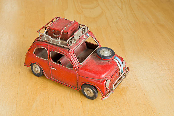 istock Old red toy car on a wooden floor. 498769497