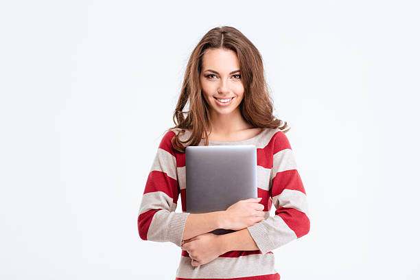 istock Smiling woman holding laptop computer 498770416