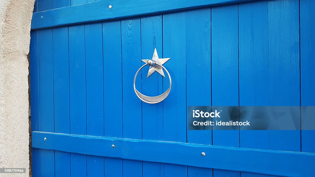 Old Blue Door Old brass knocker on painted blue front door. 2015 Stock Photo