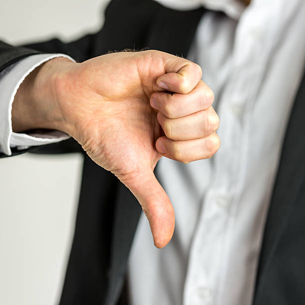 istock Man giving a thumbs down gesture of disapproval 498771331