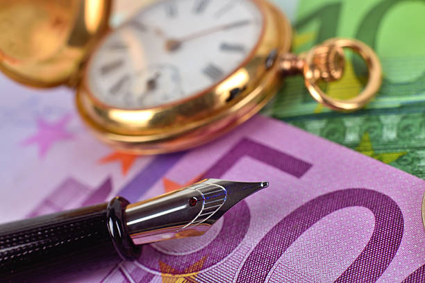 istock pocket watch, euro bills and ink pen 498771728