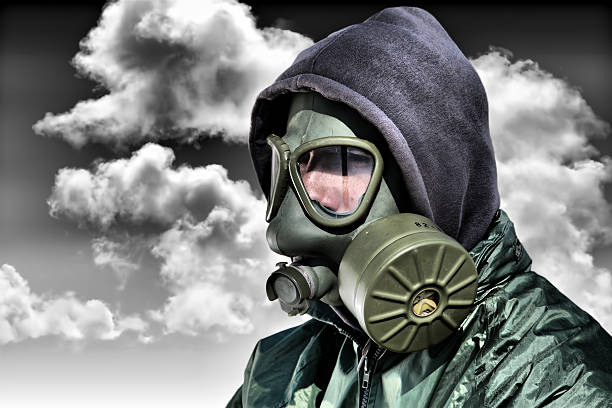 istock Man in a gas mask against polluted nature 498772003