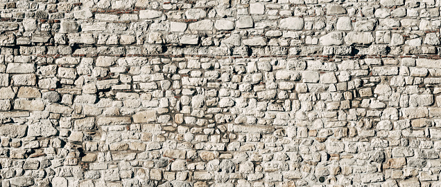 Panoramic old stone wall background