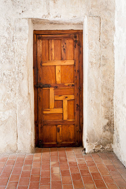 istock Wooden Door with Geometric Design and a Whitewashed Plaster Wall 498773684