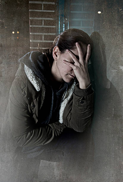 istock sad depressed woman alone leaning on street window at night 498774264