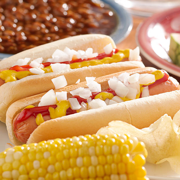 istock hot dogs with ketchup, mustard and onions. 498784253